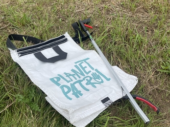 Planet Patrol bag and litter picker on grass