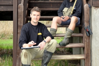 Josh Hellon sitting on the steps of  the Rothschild Bungalow