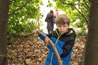 Boy with stick by Adrian Clarke