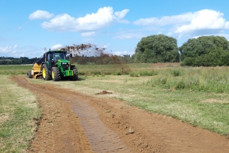 Rotary ditcher at work in the Nene Valley with ditch in foreground