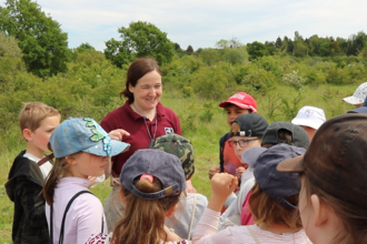 Debbie at Paxton Pits with a group of children 