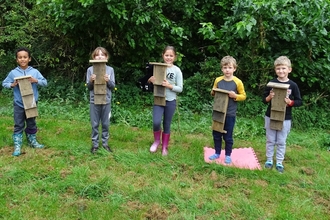 The Great Fen Wildlife Watch group with the bat boxes they made