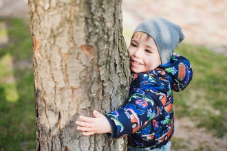 Child hugging tree
