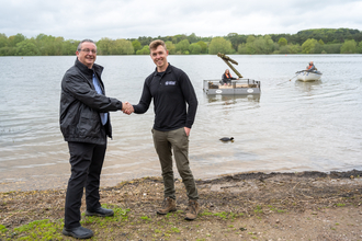 Nathan Long Corporate Partnerships Manager Shaking hands with IM Kelly staff