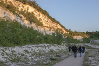 A group walking through chalkland habitat 