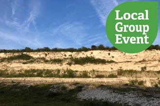 Sun shining on the chalk cliff at East pit, "Local Group event" icon overlaid