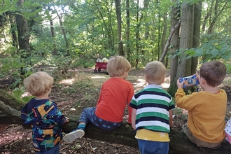 children on log in Cambourne Nature Reserve by Rebecca Neal