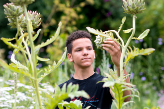 Teenager and artichoke by Gavin Dickson
