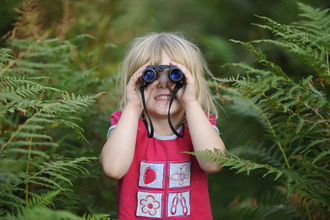 Girl holding binoculars