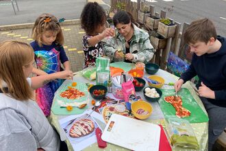 Families making scary pizzas