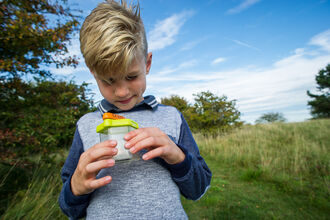 Boy with bug pot by Matthew Roberts