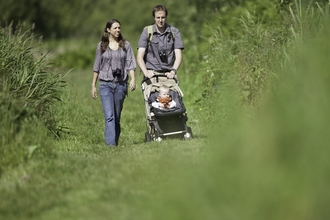 Family walking through a nature reserve