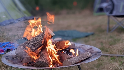 Camp fire and tents by Rebecca Neal