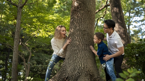 Adults and child playing by a tree from Freepik.com