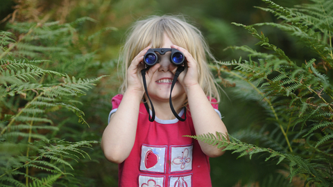 Girl holding binoculars