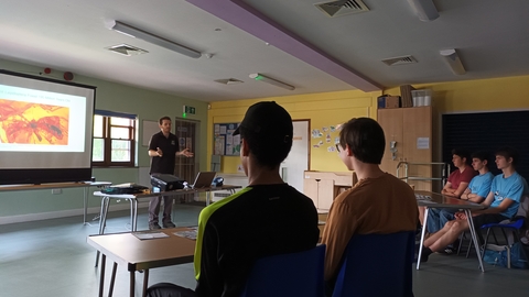 Young people listening to talk in classroom