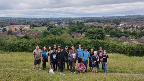 Group of young people standing on a hillside