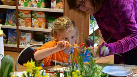 Woman and child painting plant pot