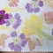A printing with pink and yellow flowers and red and green leaves