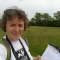 Lucy Wilson in a Wildlife Trust t-shirt in a field