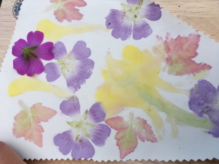 A printing with pink and yellow flowers and red and green leaves