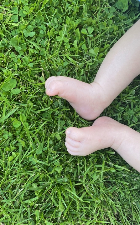Arthur enjoying the grass on his bare feet