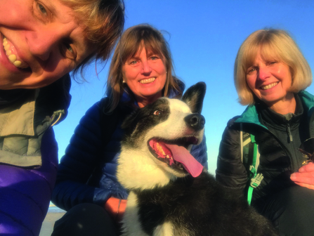 Three of our livestock volunteers with their sheep dog.