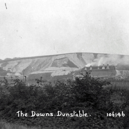 Black and white photograph of the Dunstable downs chalk hill with a factory on the hill