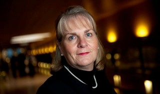 A woman smiles at the camera