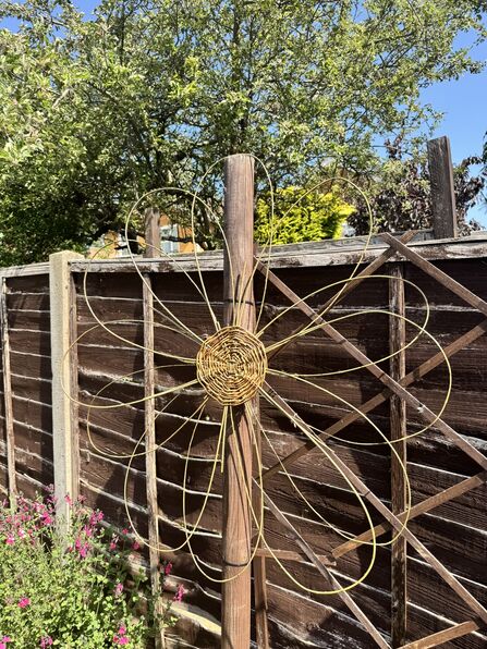 willow weaved flower on fence