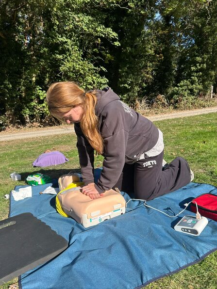 a trainee giving CPR to a dummy 
