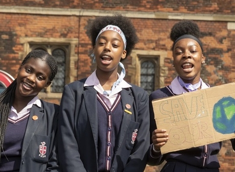 Young people with placard by Penny Dixie