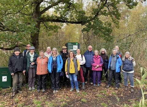 Group of people dressed warmly smiling to camera