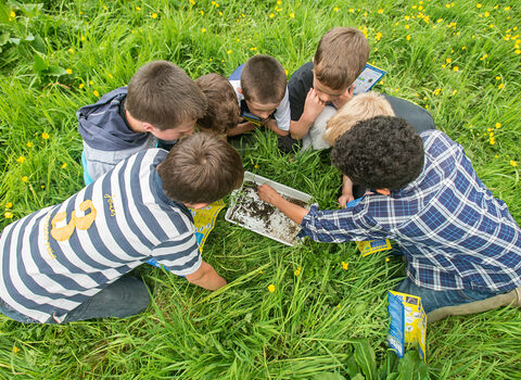 Children around a white tray by Ross Hoddinott/2020VISION