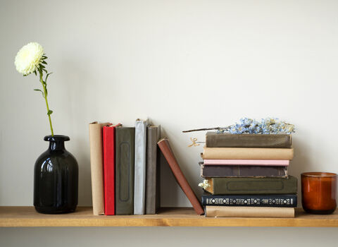 A bookshelf adorned with flowers